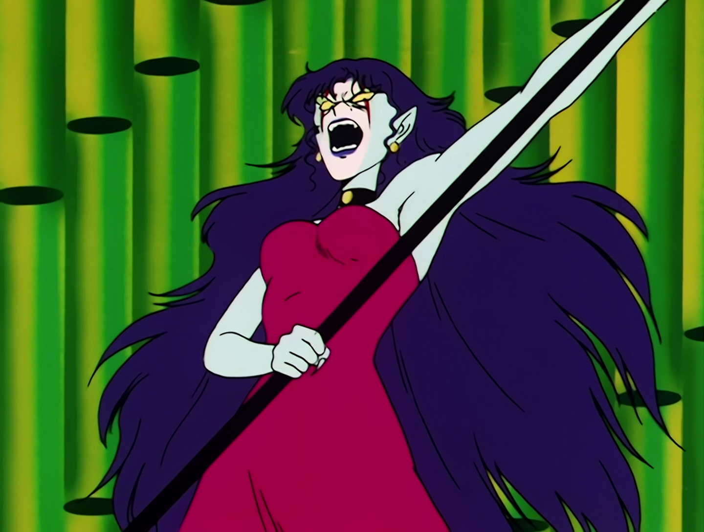 Ramua, a Youma from Sailor Moon episode 9. She has pale white skin, bark blue hair, and red markings on her face. She wears a red dress and wields a giant clock hand as a weapon, which feels a bit redundant as she can also, you know, control time.